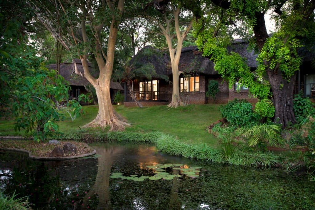 a suite exterior view with green grass in the front at Stanley & Livingstone Boutique Hotel with Ker & Downey Africa