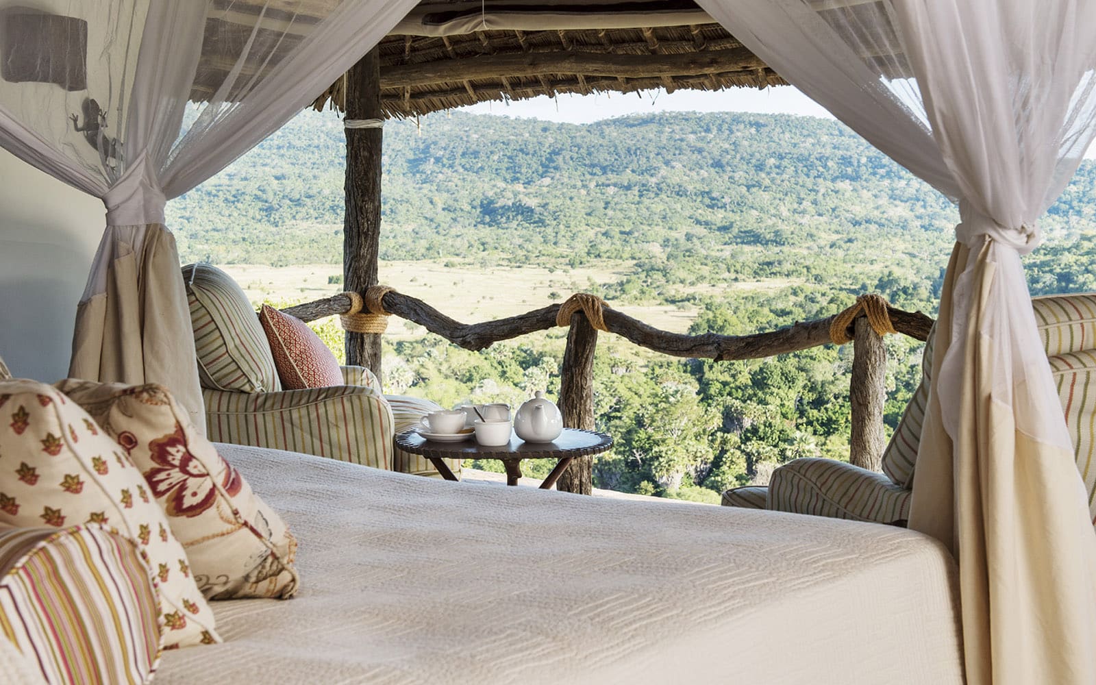Bailey&rsquo;s Banda bedroom with sweeping views, one of the lodges in Tanzania with Ker & Downey Africa