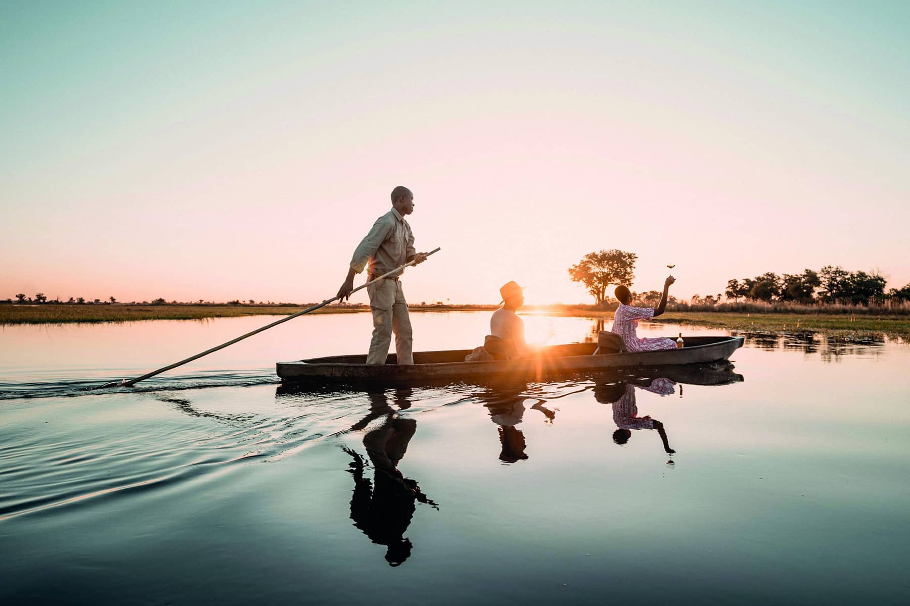 Guests on a mokoro sunset cruise